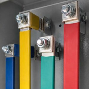 Close-up of color-coded copper busbar tap connections inside the plug-in box