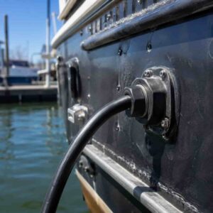 Water-blocking cable installed on vessel hull outboard connection