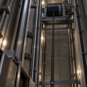 Elevator composite cable installed in lift shaft with drum feeding system
